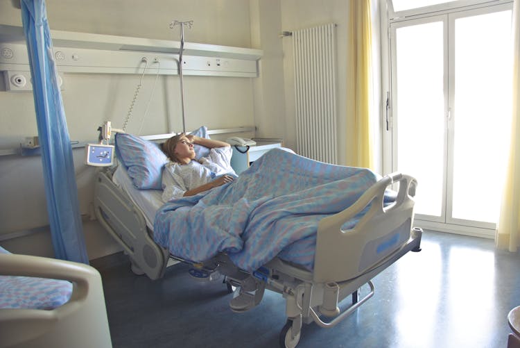 Photo Of Woman Lying In Hospital Bed