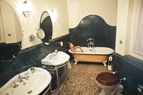 Woman Relaxing in a Bathtub Inside a Bathroom