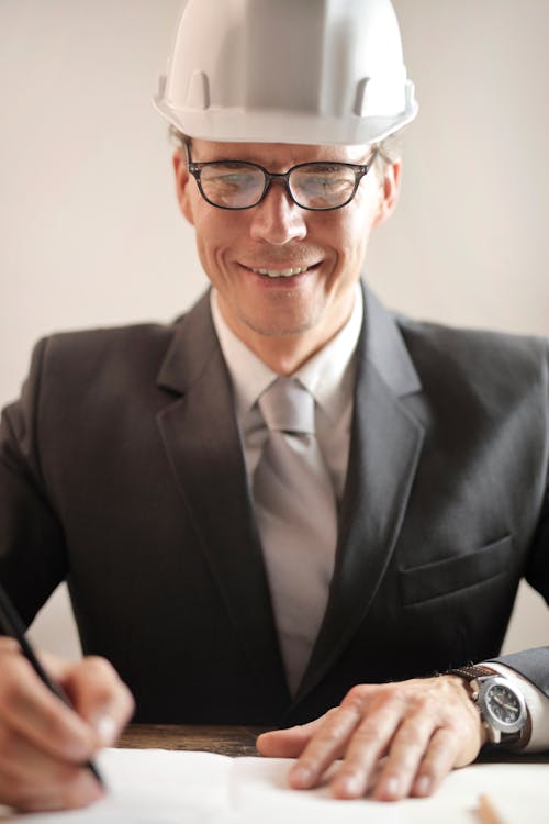 Free Man in Black Suit Signing A Paper works Stock Photo