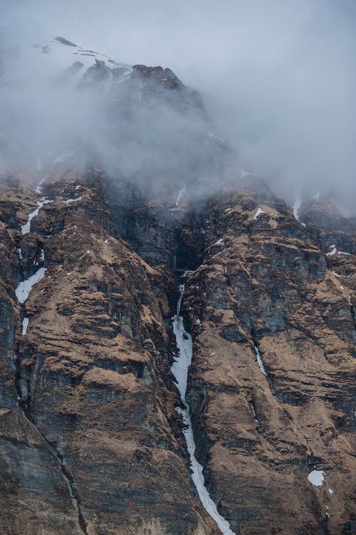 Free A breathtaking view of the Himalayan peaks partially covered by mist, showcasing rugged beauty. Stock Photo