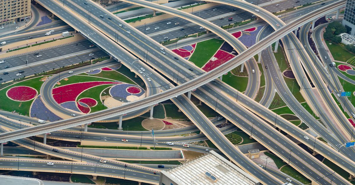Aerial view of a complex highway interchange in Dubai, showcasing modern urban infrastructure.