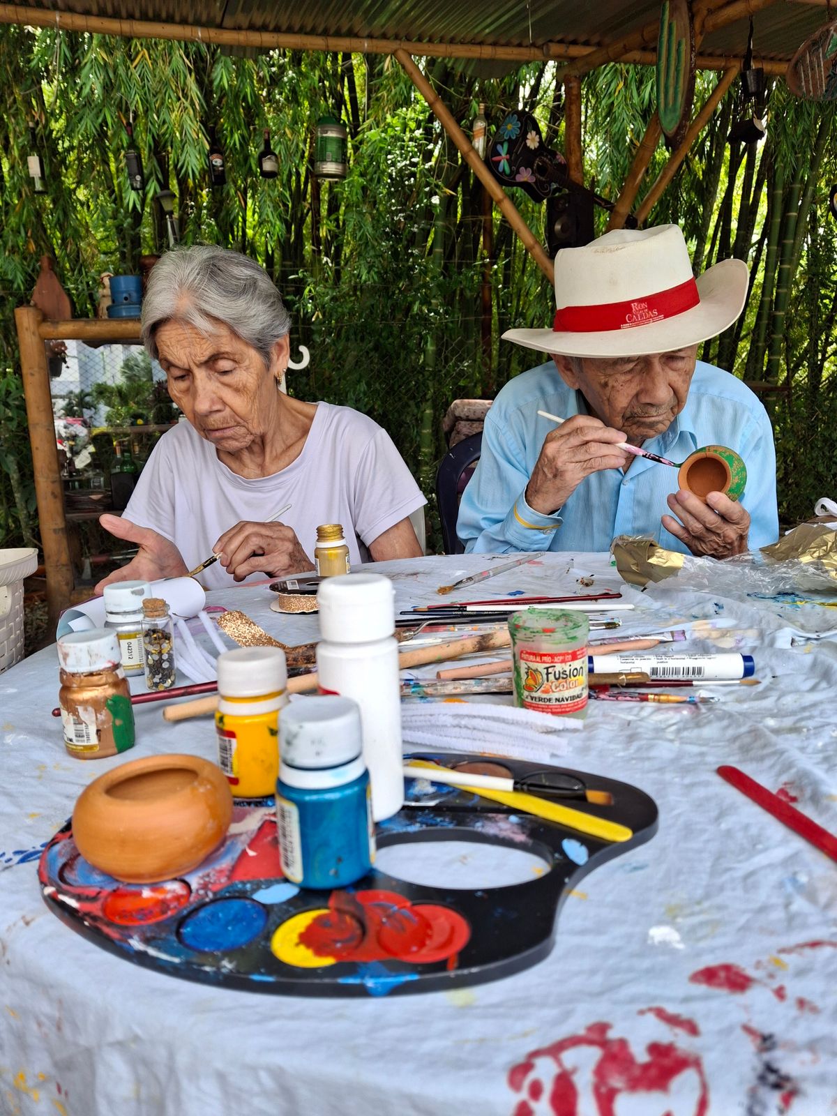 Seniors painting together at a community table
