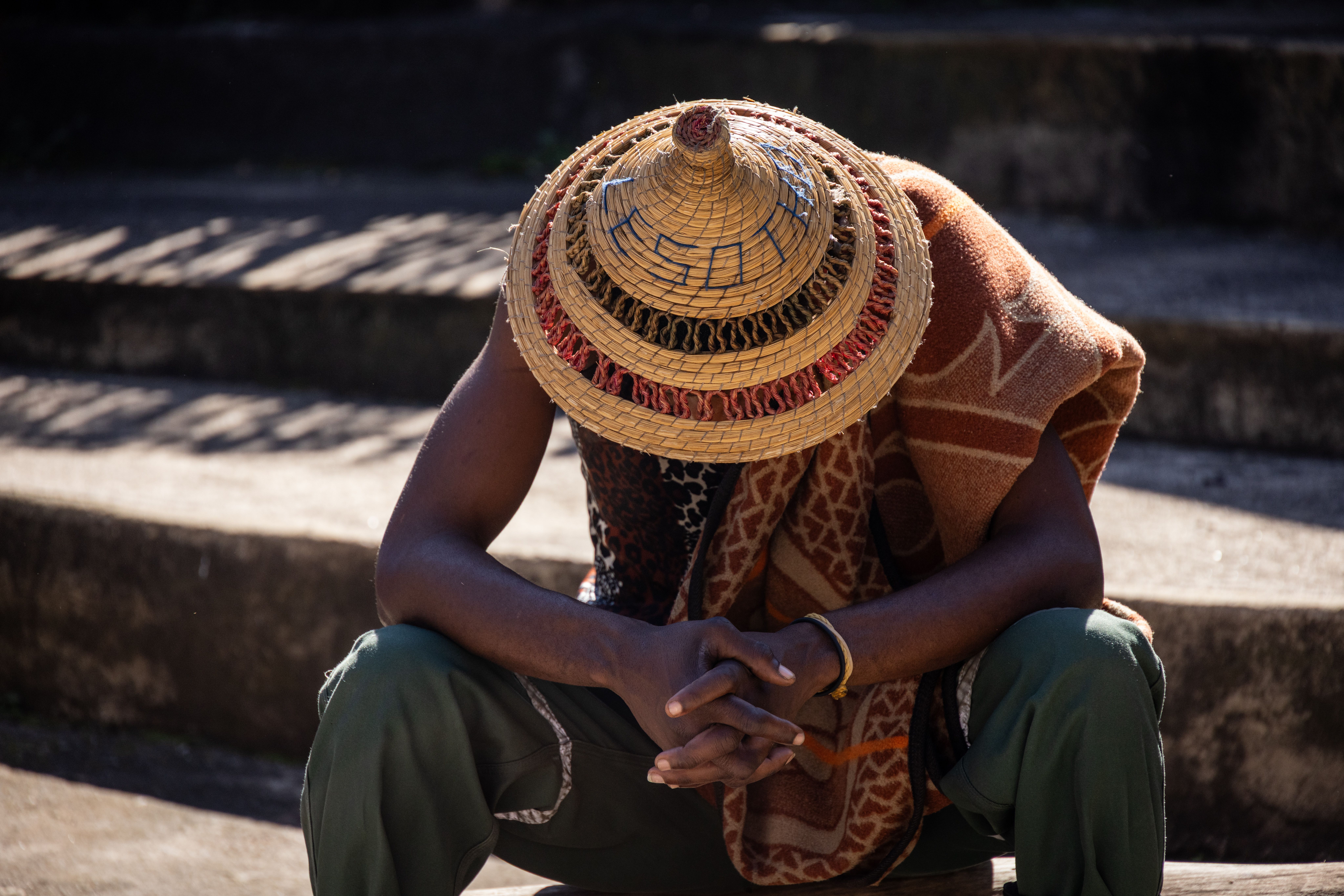 Traditional straw hat worn by seated man, Zimbabwe