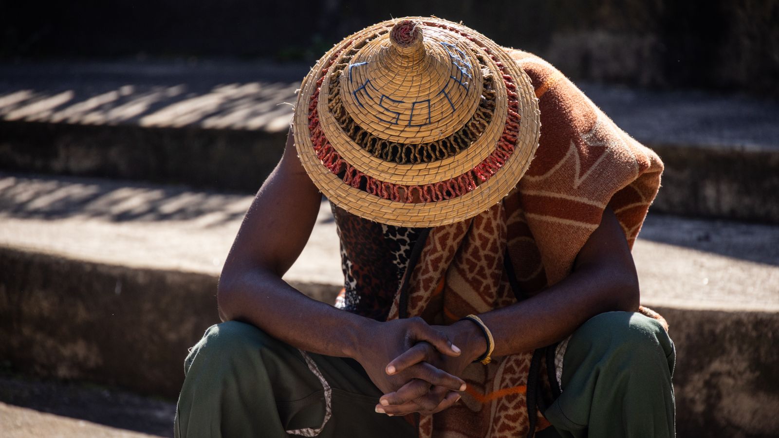 Traditional straw hat worn by seated man, Zimbabwe