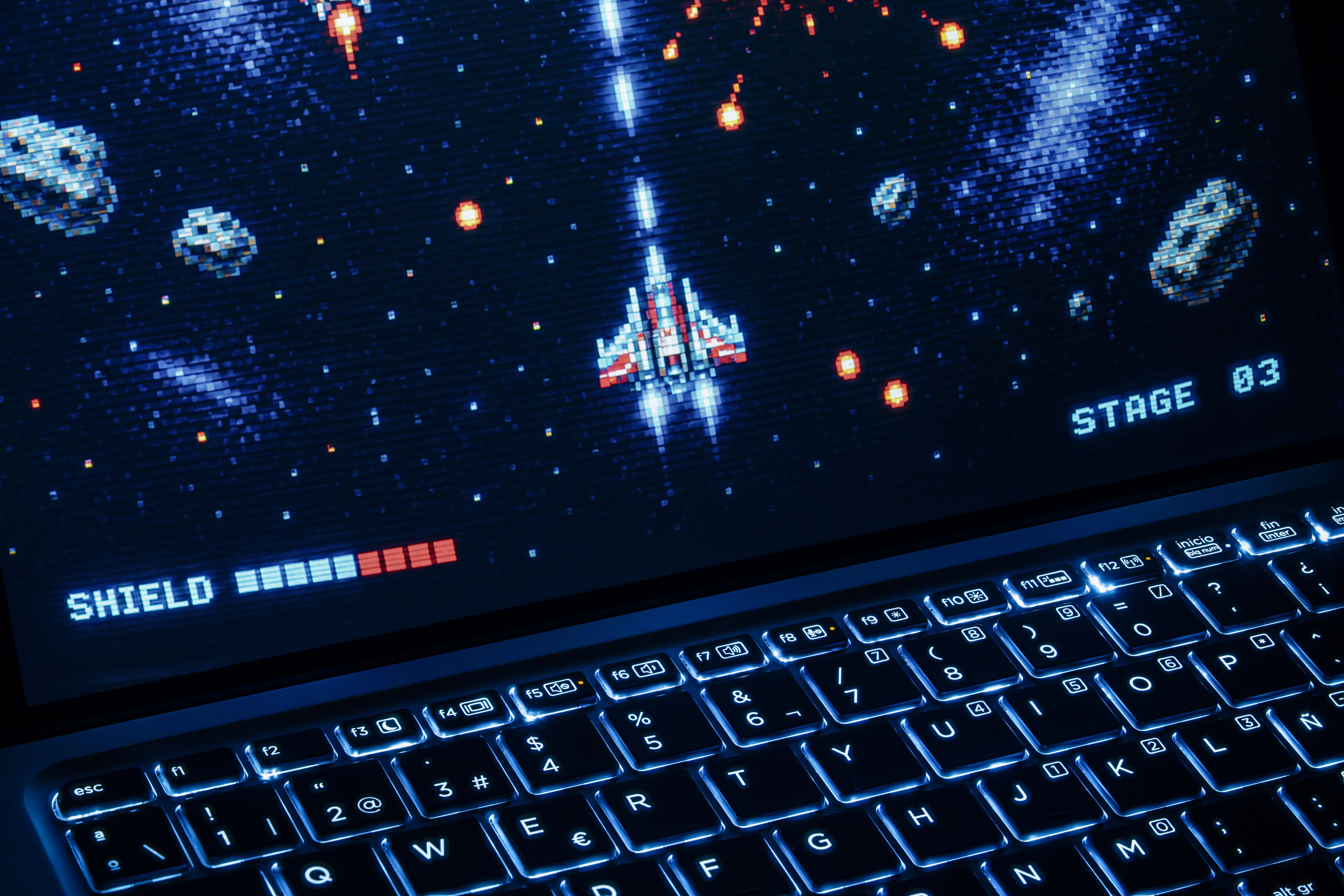 Retro Arcade Space Shooter on Laptop Screen · Free Stock Photo