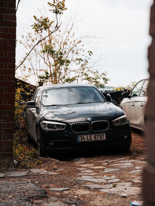 Free BMW car captured in a rustic, outdoor setting, offering a moody and cinematic feel. Stock Photo