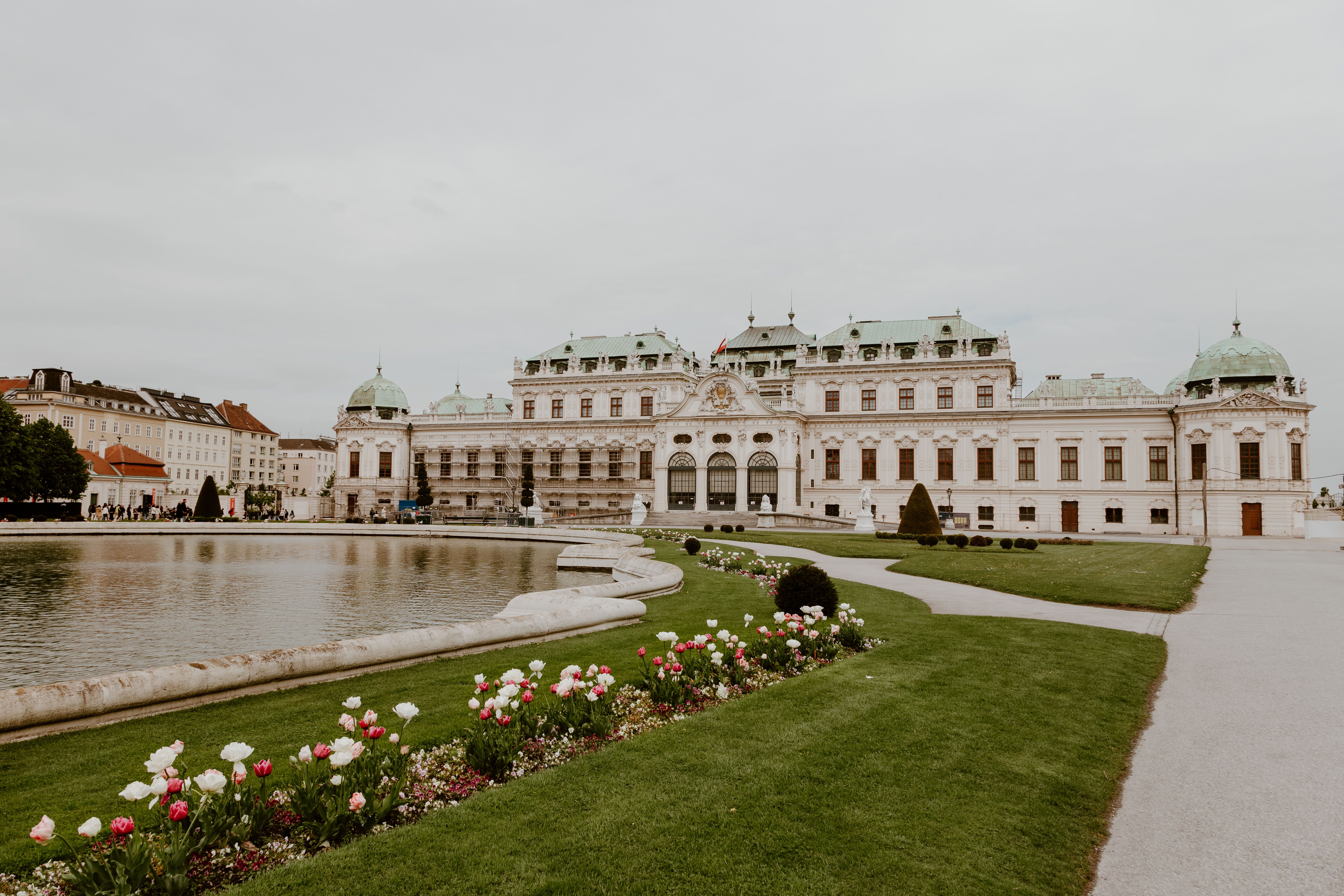 Elegant shot of the Belvedere Palace in Vienna, Austria, with beautiful gardens and reflecting pond.