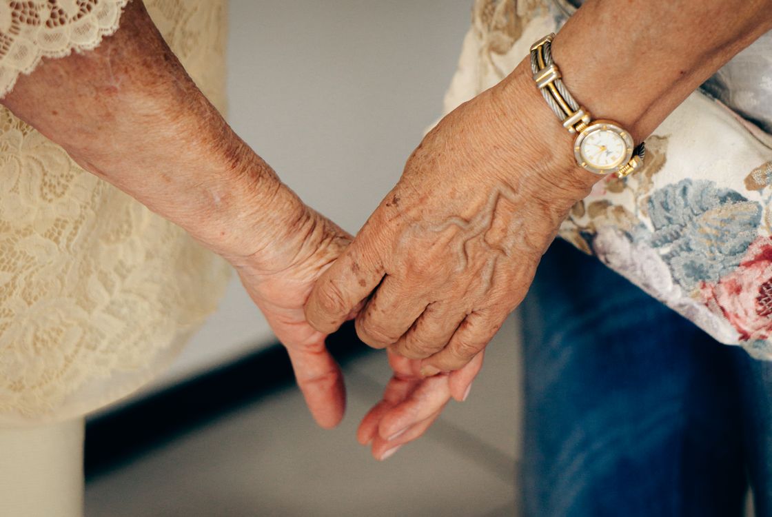 Free Close-up of elderly hands holding each other, symbolizing care and companionship. Stock Photo