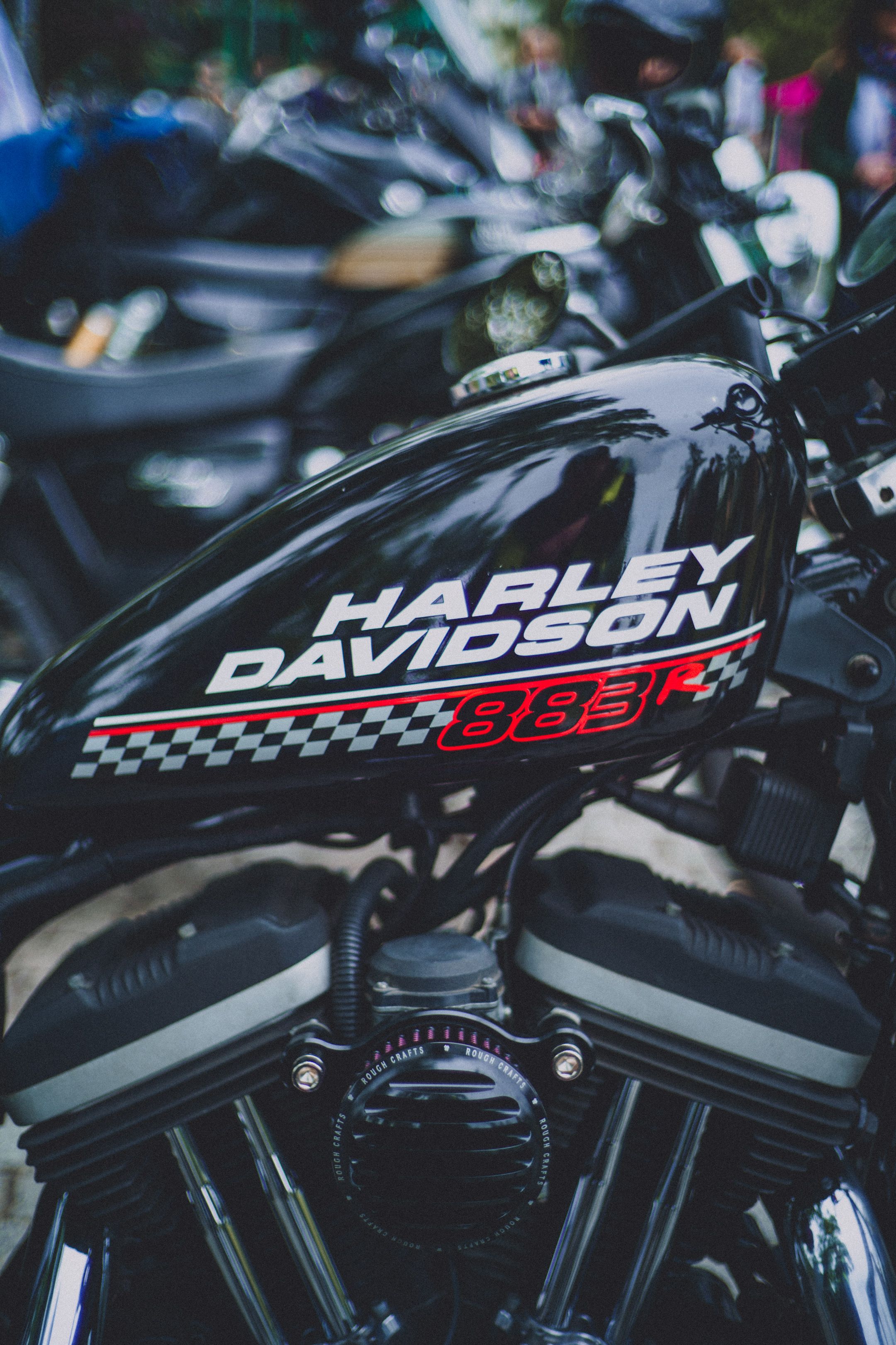 Detailed view of a Harley Davidson motorcycle tank showcasing brand logo and design elements.