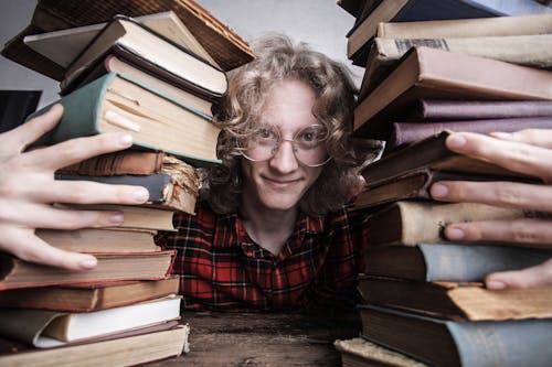 A Man Holding His Old Books