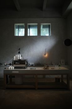 Modern minimalist coffee bar interior with espresso machine.