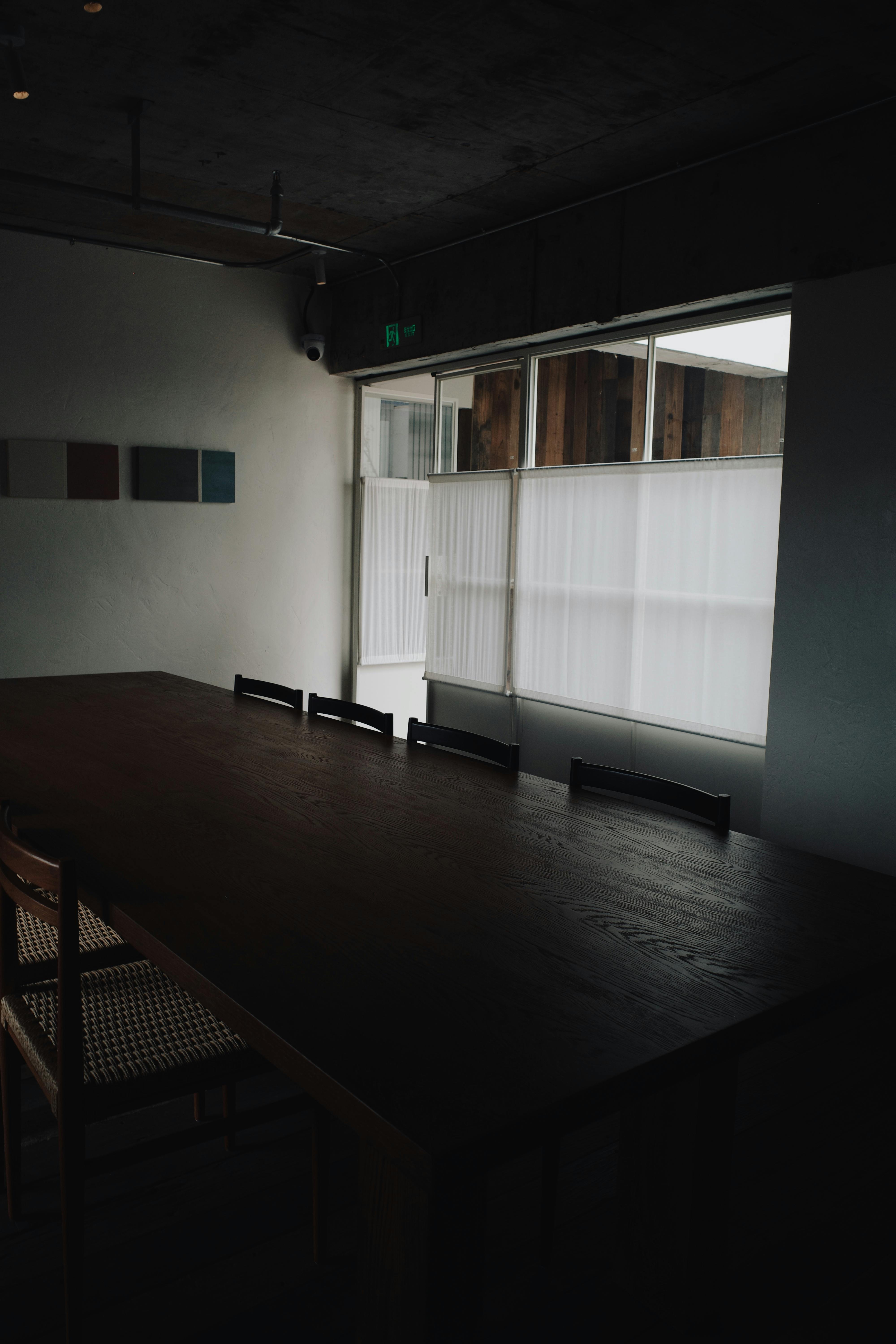 Empty dark conference room with sleek furniture and minimalistic decor.