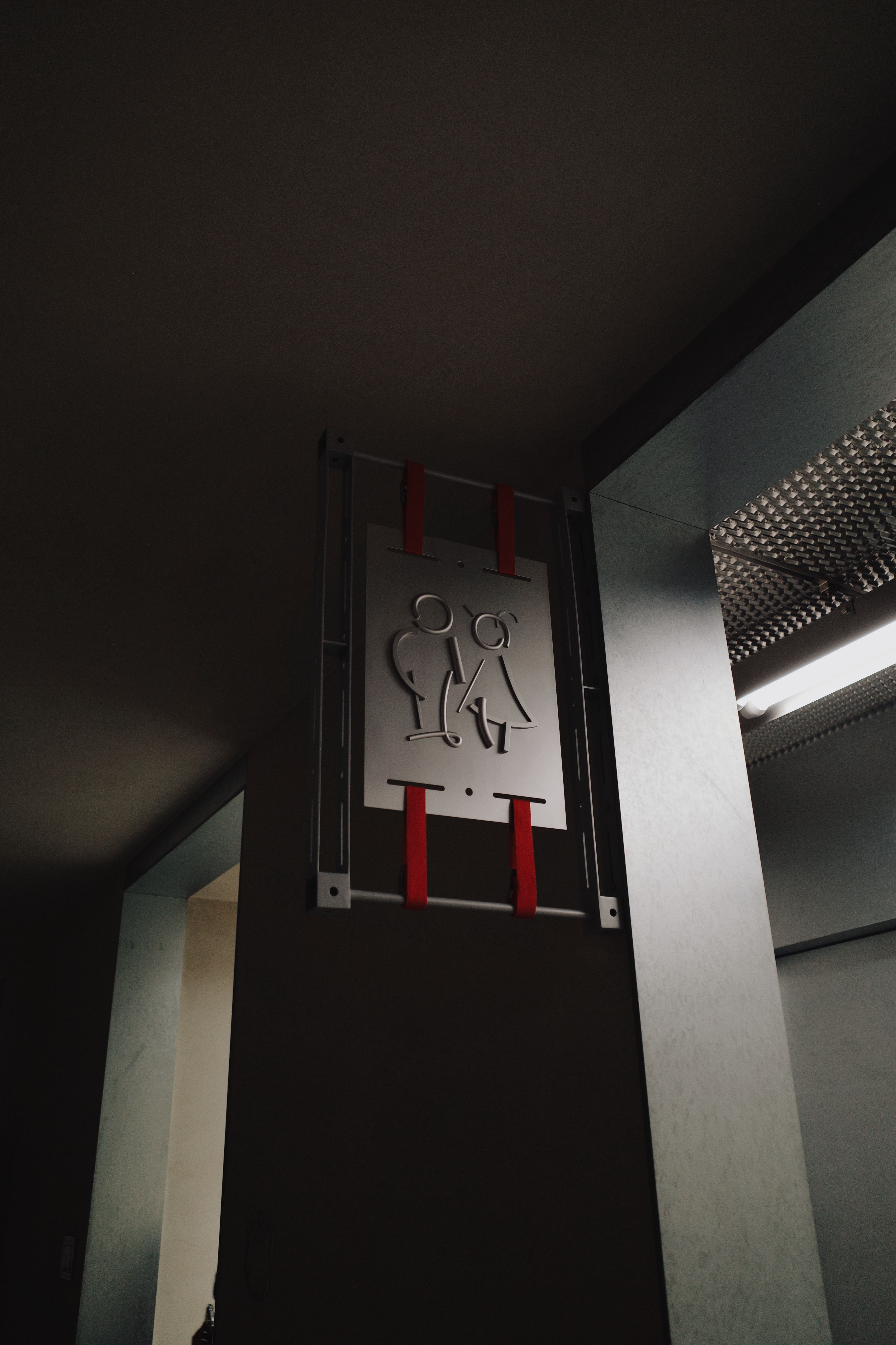 Minimalist Restroom Sign in Subdued Lighting · Free Stock Photo