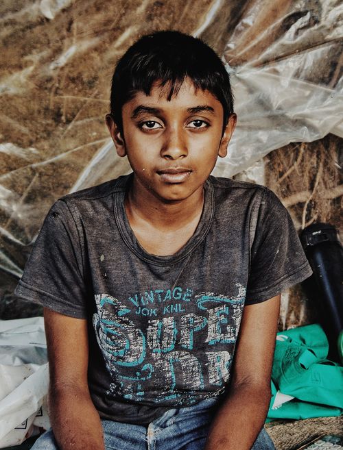 Free Close-up portrait of a boy in a casual setting, expressing thoughtfulness. Stock Photo