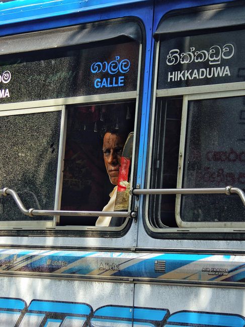 A passenger looking through a bus window in Sri Lanka A passenger looking through a bus window in Sri Lanka