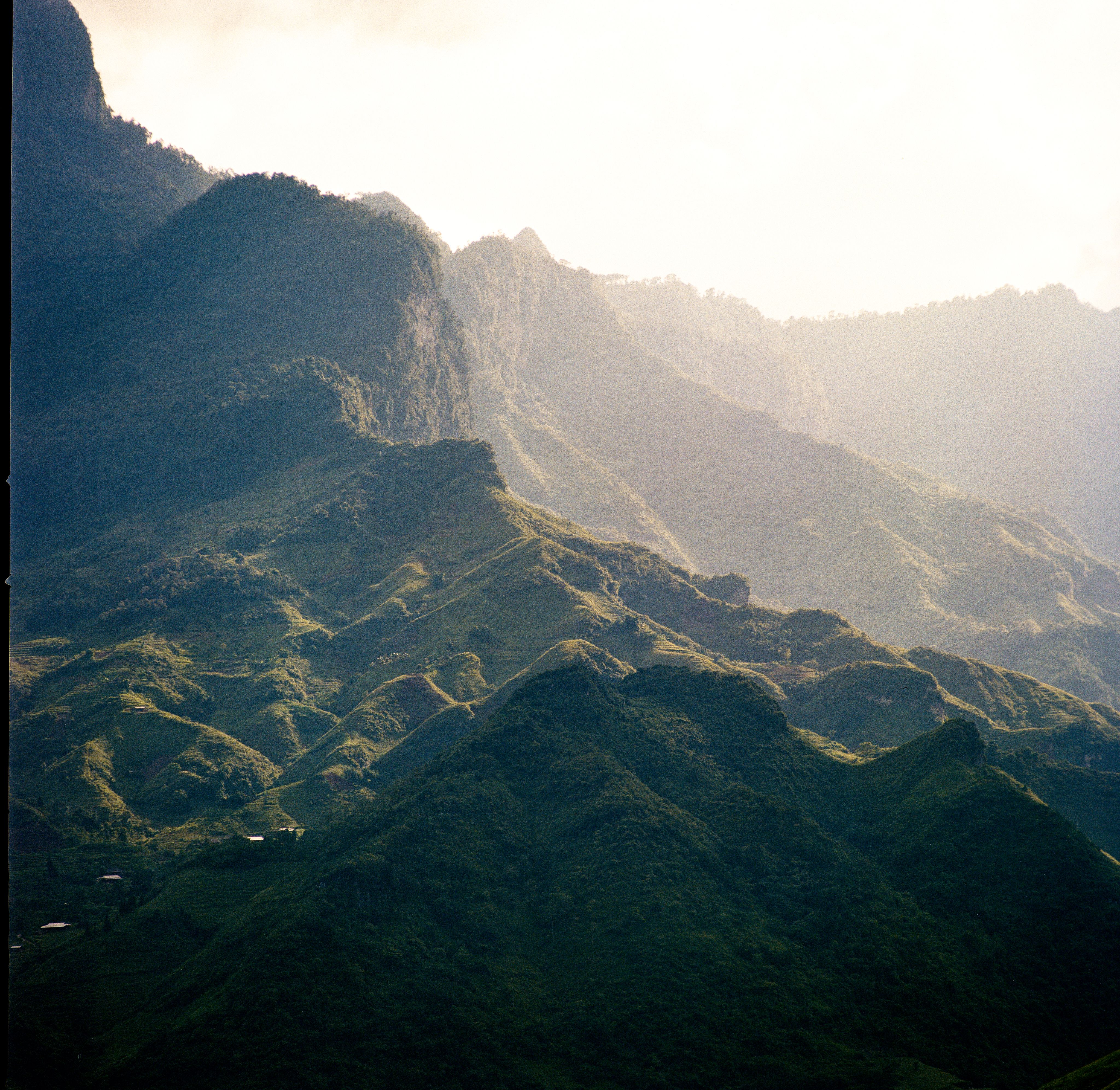 Beautiful green mountain landscape illuminated by soft morning light, showcasing natural beauty.