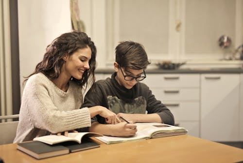Free Elder sister and brother studying at home Stock Photo