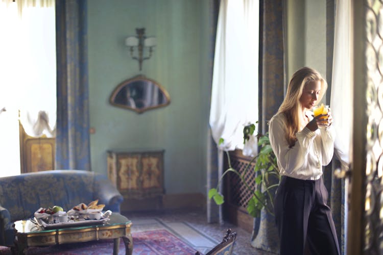 Young Woman Drinking Fresh Juice At Home