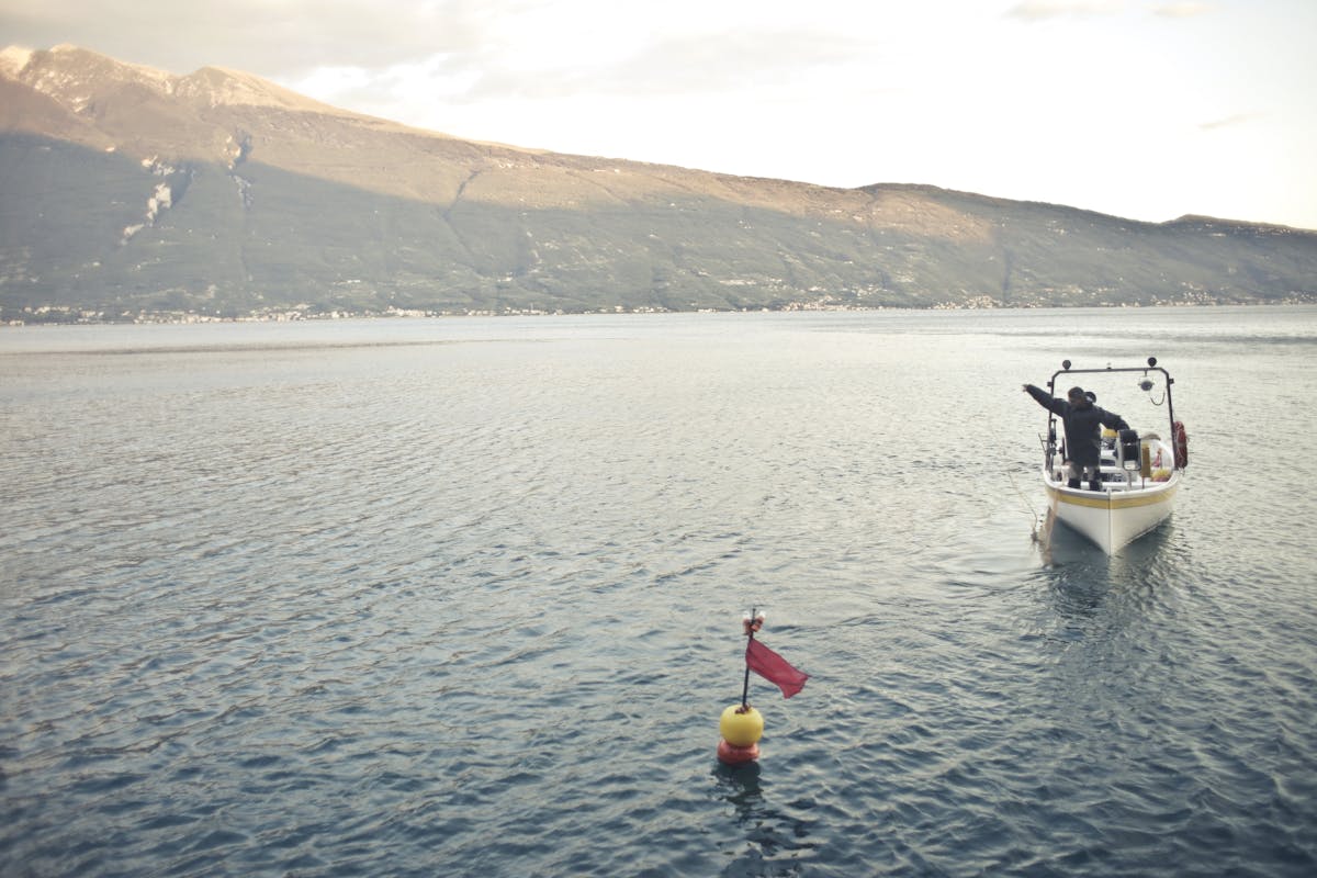 A breakfast table set with bowls of oats, fruit, yogurt, and coffee in soft natural light