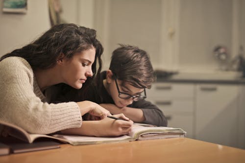 Focused students doing homework at home