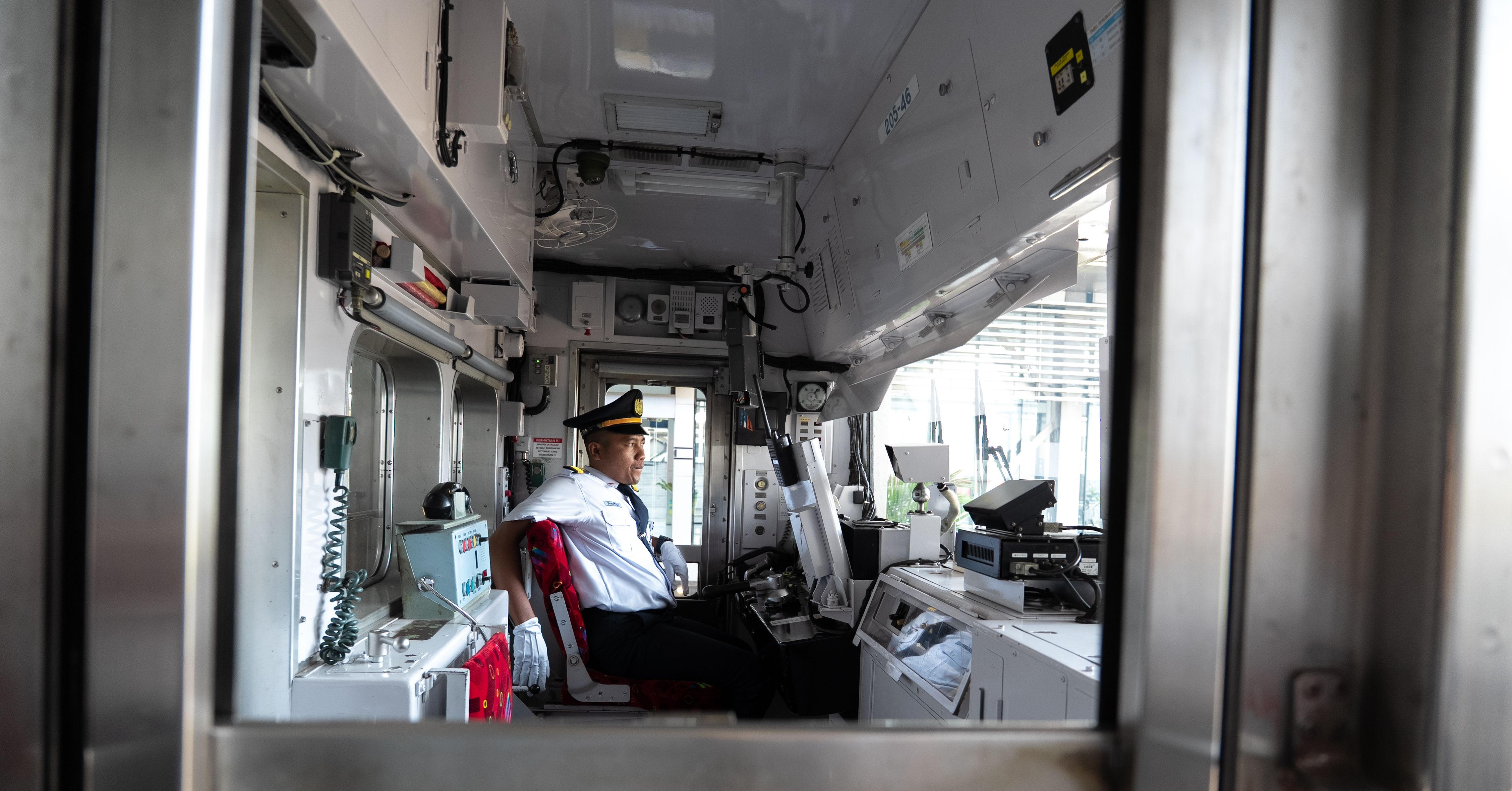 SEPTA train conductor looking stressed while speaking on a radio inside the cabin