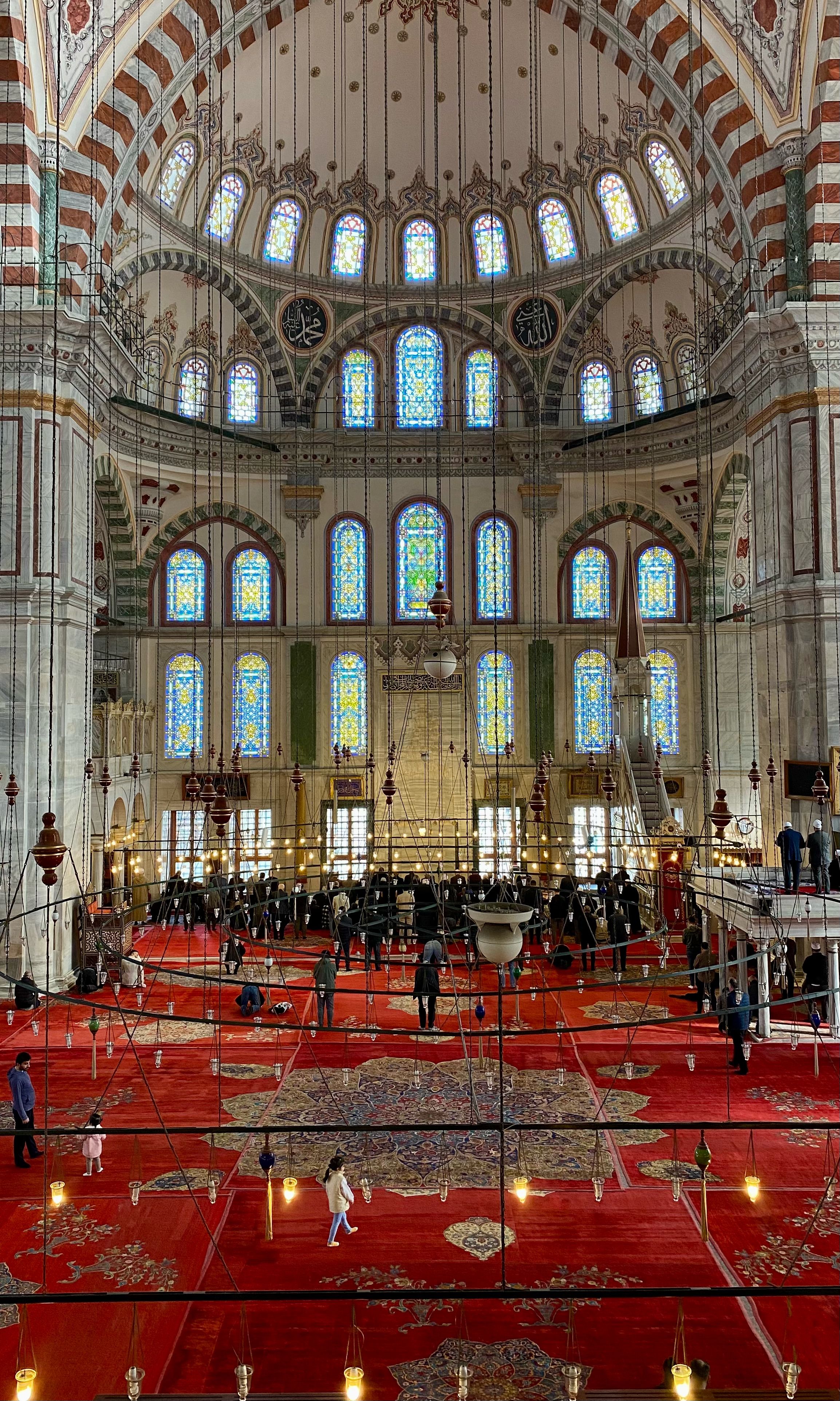 Stunning architecture and vibrant stained glass inside Süleymaniye Mosque, Istanbul.