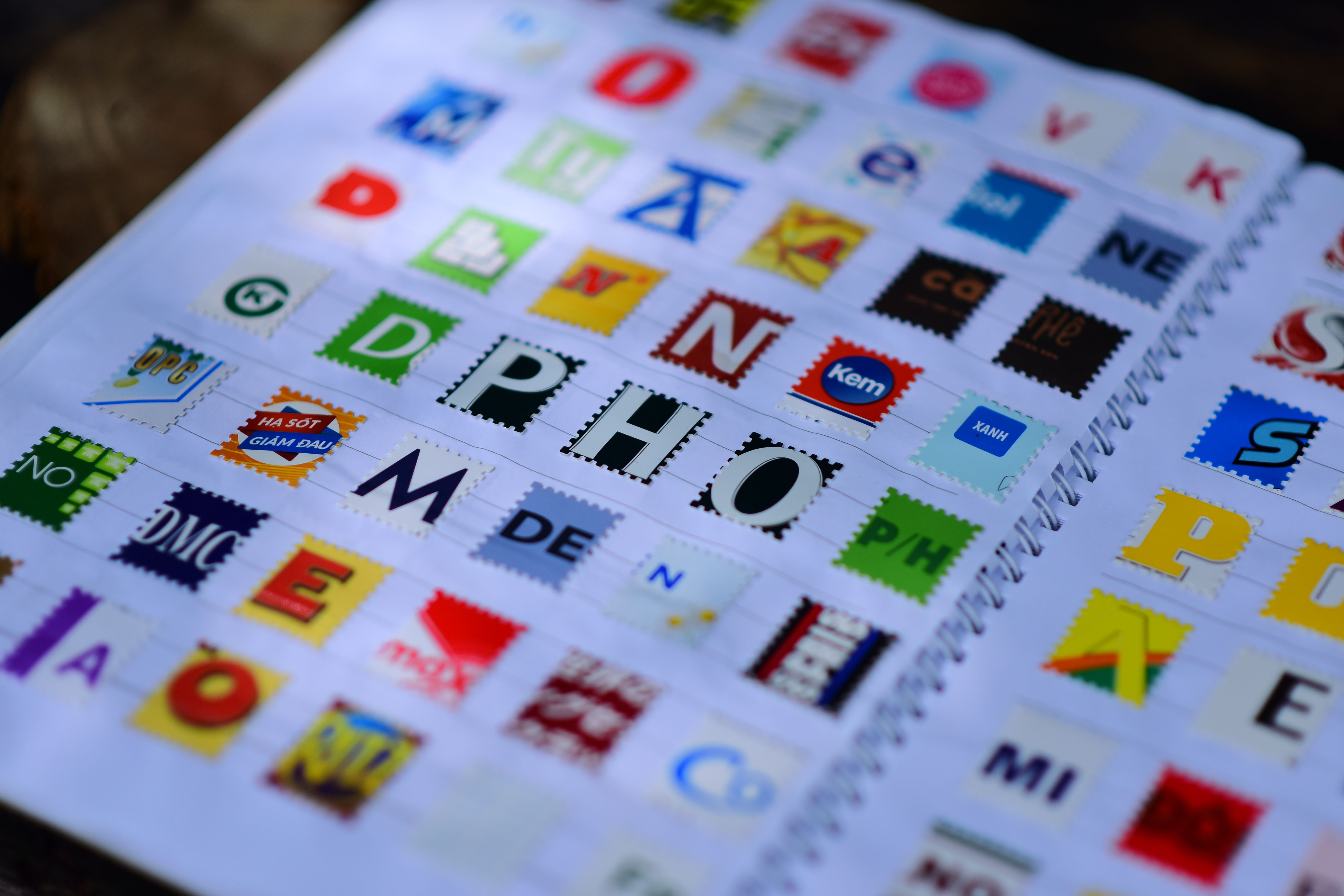 A spiral notebook featuring a creative and colorful alphabet collage with various design styles.