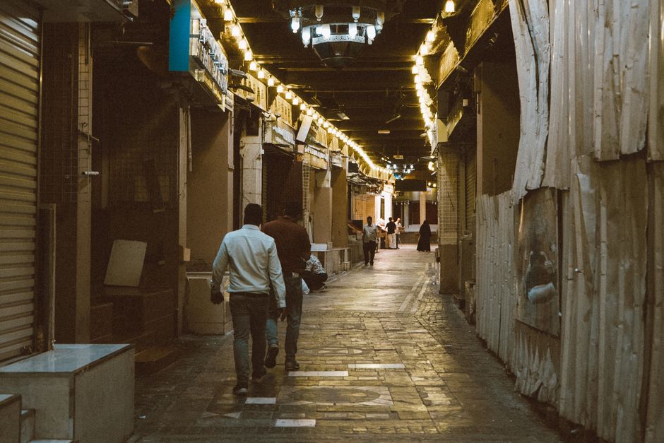 A bustling scene at Manama Souq (Bab Al Bahrain Souq) with colorful goods
