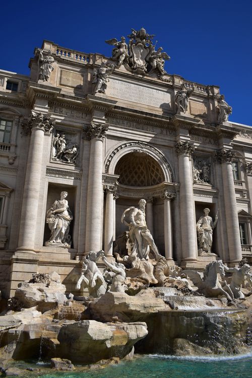 Free Stunning image of the Trevi Fountain's sculptures and architecture in Rome under a clear blue sky. Stock Photo
