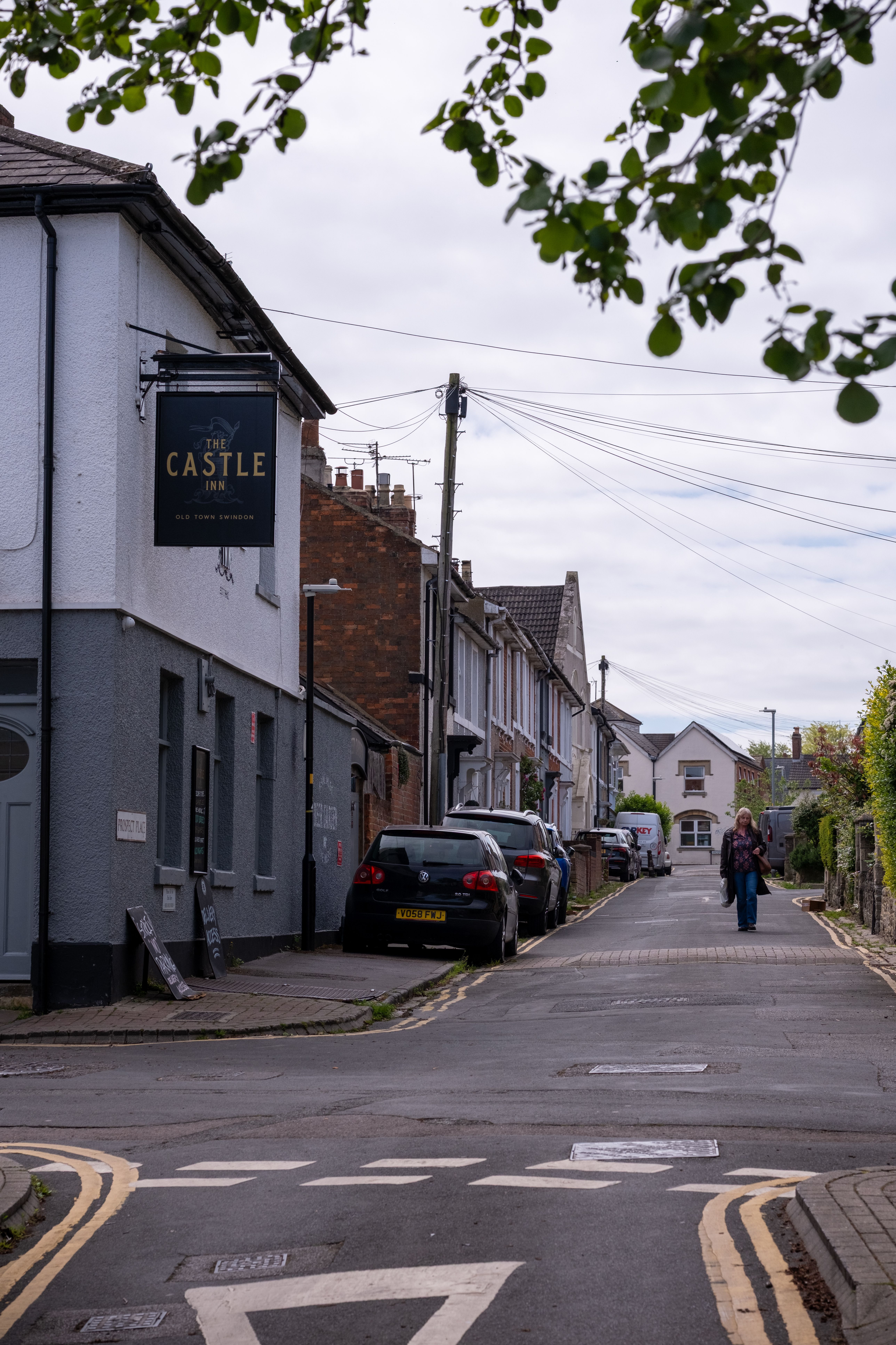 Charming street view in Swindon, England, showcasing classic architecture and daily life.