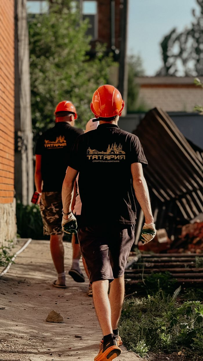 Construction workers in safety helmets on site