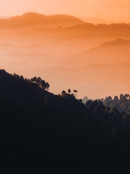 Breathtaking sunrise view of misty mountains in Azad Jammu and Kashmir with a warm, vibrant glow.
