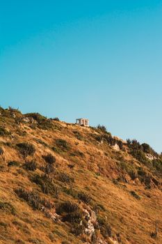 Picturesque hill with a small structure in Arraial do Cabo, Brazil.