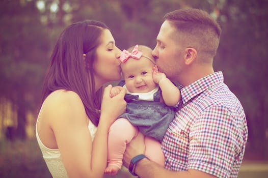 Couple Kissing Baby While Carry