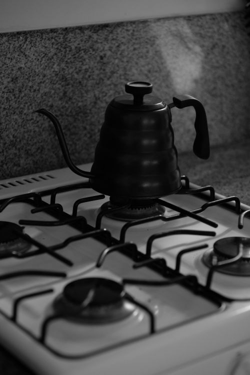 Free Elegant black kettle on gas stove, emphasizing homebrew coffee culture. Stock Photo