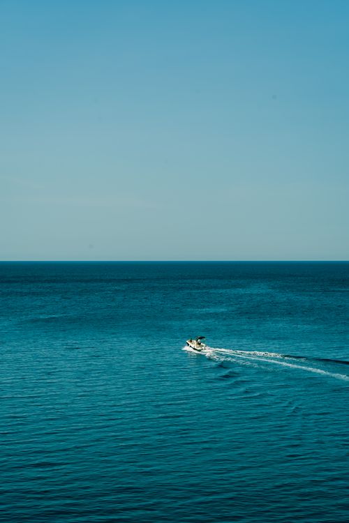 Free A speedboat cruising on the blue Balearic Sea with clear skies on a sunny day, capturing the essence of adventure. Stock Photo