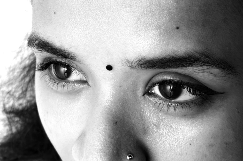 Artistic black and white close-up of eyes with traditional Indian bindi.