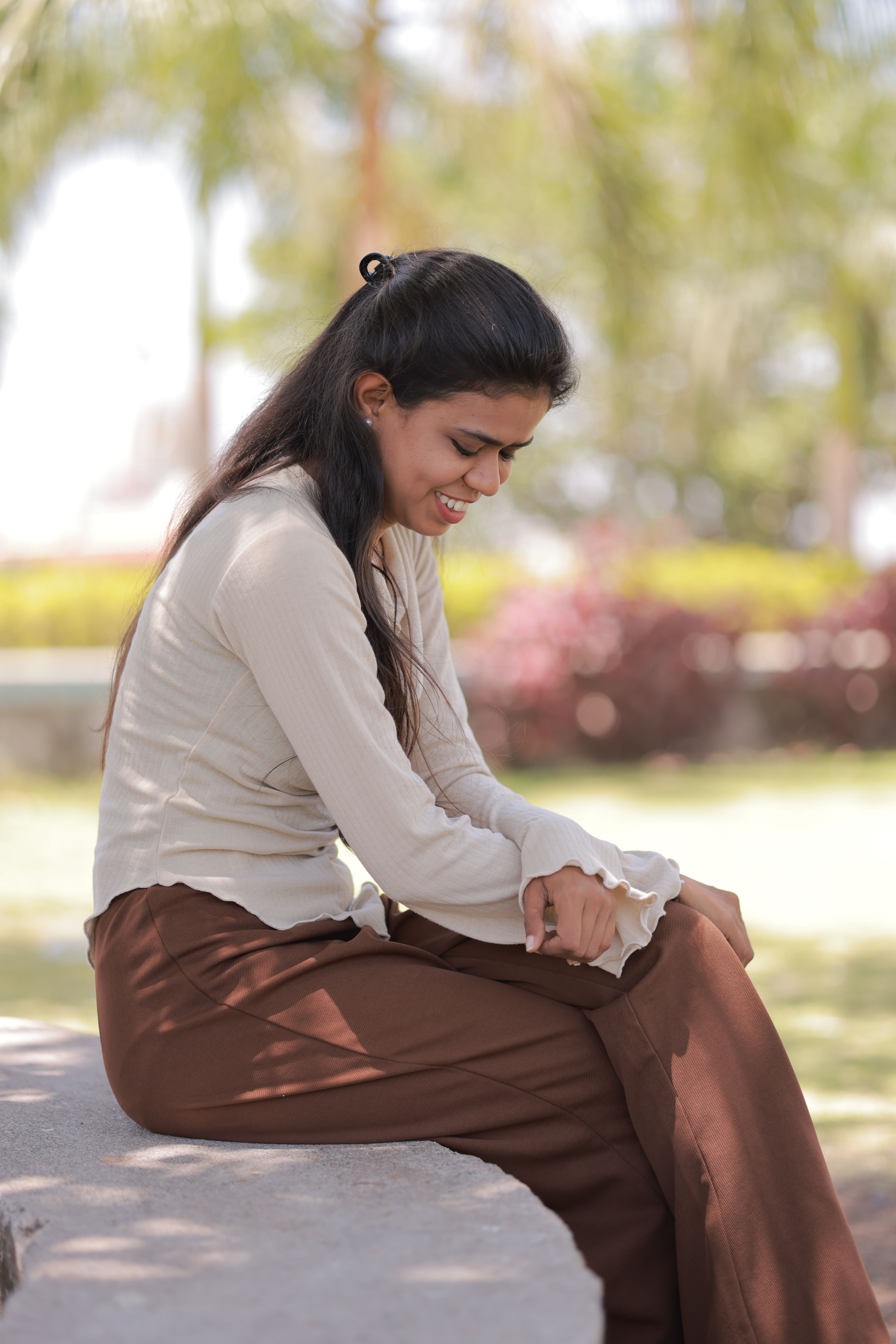 Contemplative woman seated on a park bench outdoors · Free Stock Photo