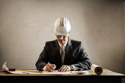 Free Professional architect working with draft in office Stock Photo
