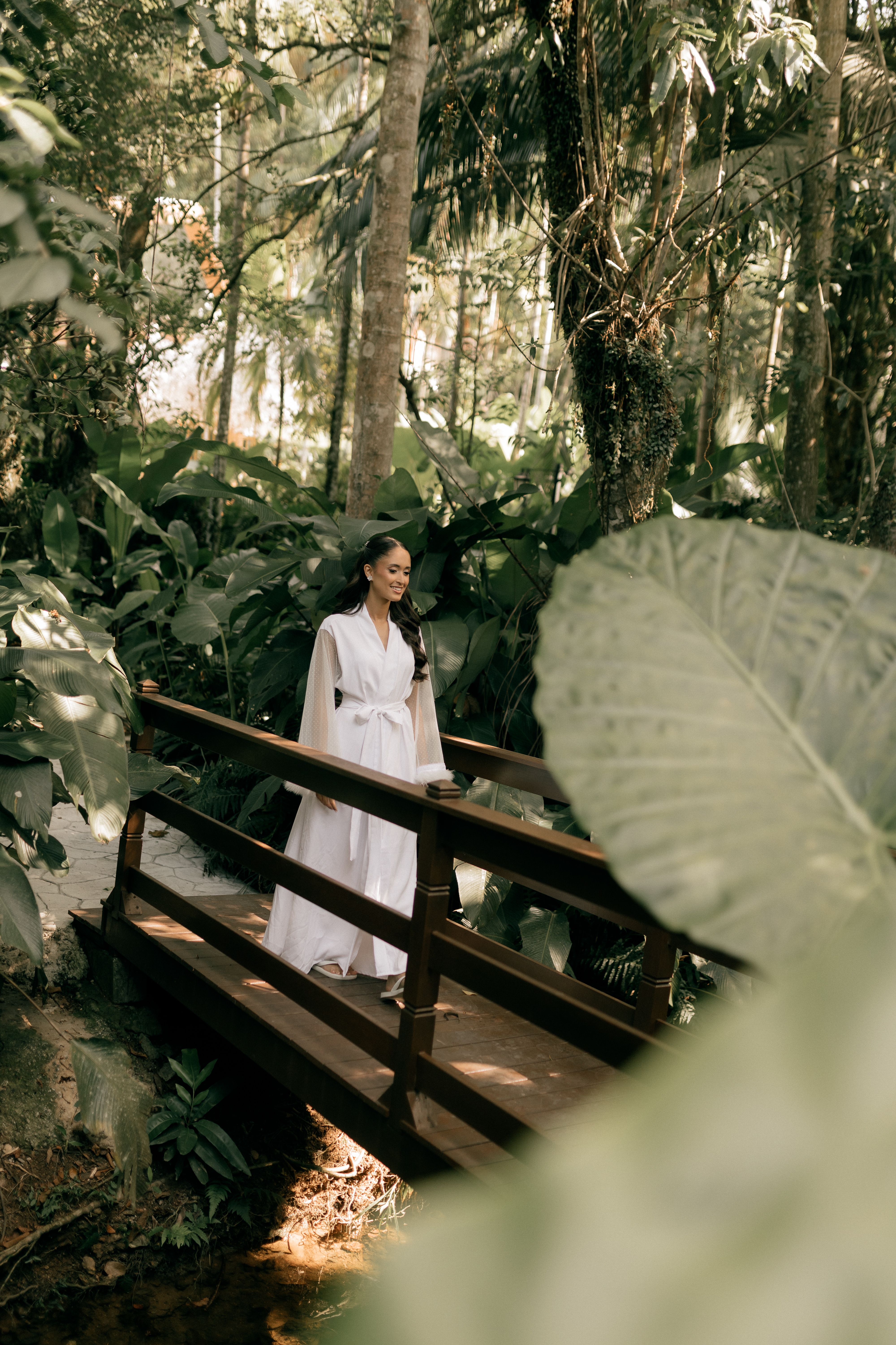 Woman walking on a wooden bridge through the forest