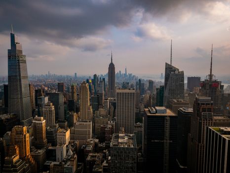 Aerial view of New York City's iconic skyline with dramatic cloud cover.