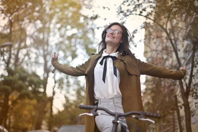 Content Woman In Retro Clothes On Bicycle In Street