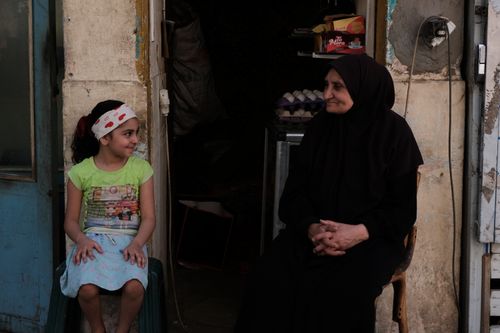 Free Heartwarming interaction between a child and elderly woman on a street in Cairo, Egypt. Stock Photo