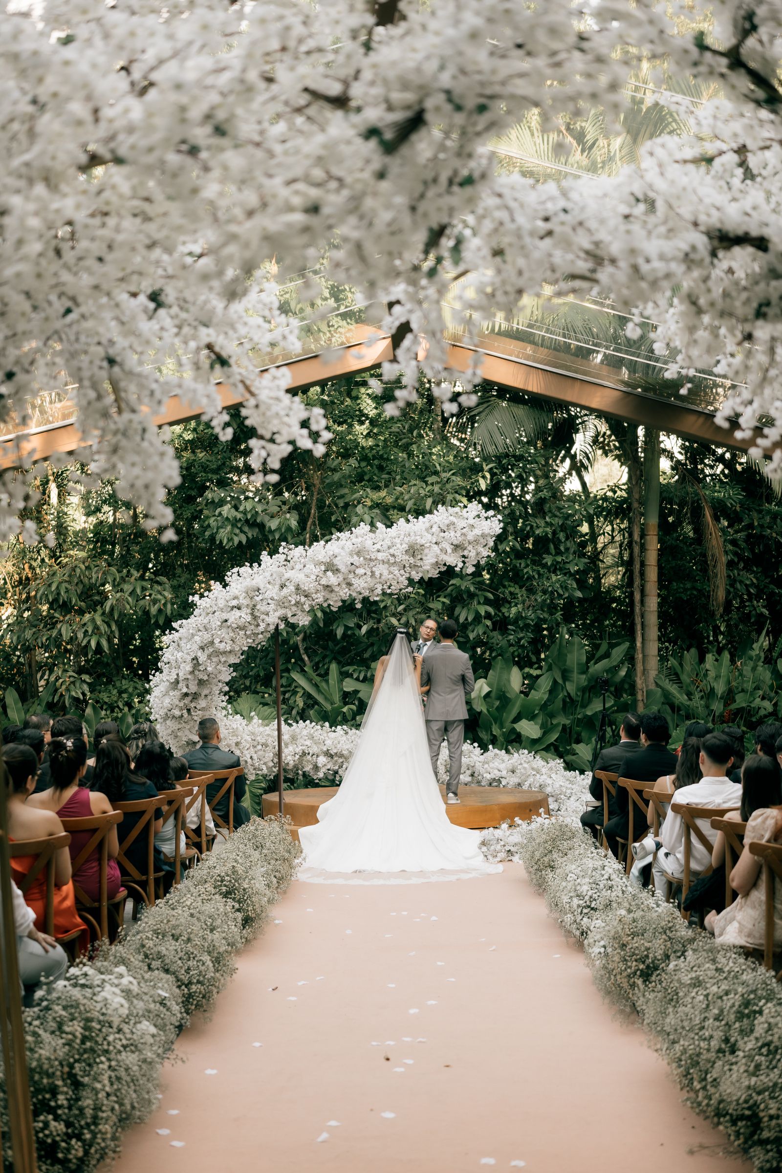 Circular floral arch at an outdoor wedding ceremony
