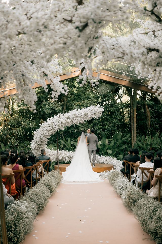 Circular floral arch at an outdoor ceremony