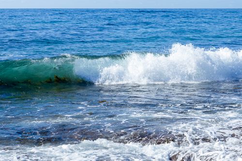 Free Crystal blue waves crashing on rocks at Culburra Beach, Australia. Stock Photo