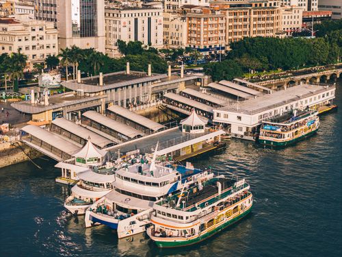 Free Aerial view of bustling Xiamen ferry terminal with docked ships and urban skyline. Stock Photo