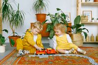 Two children playing with a toy train together