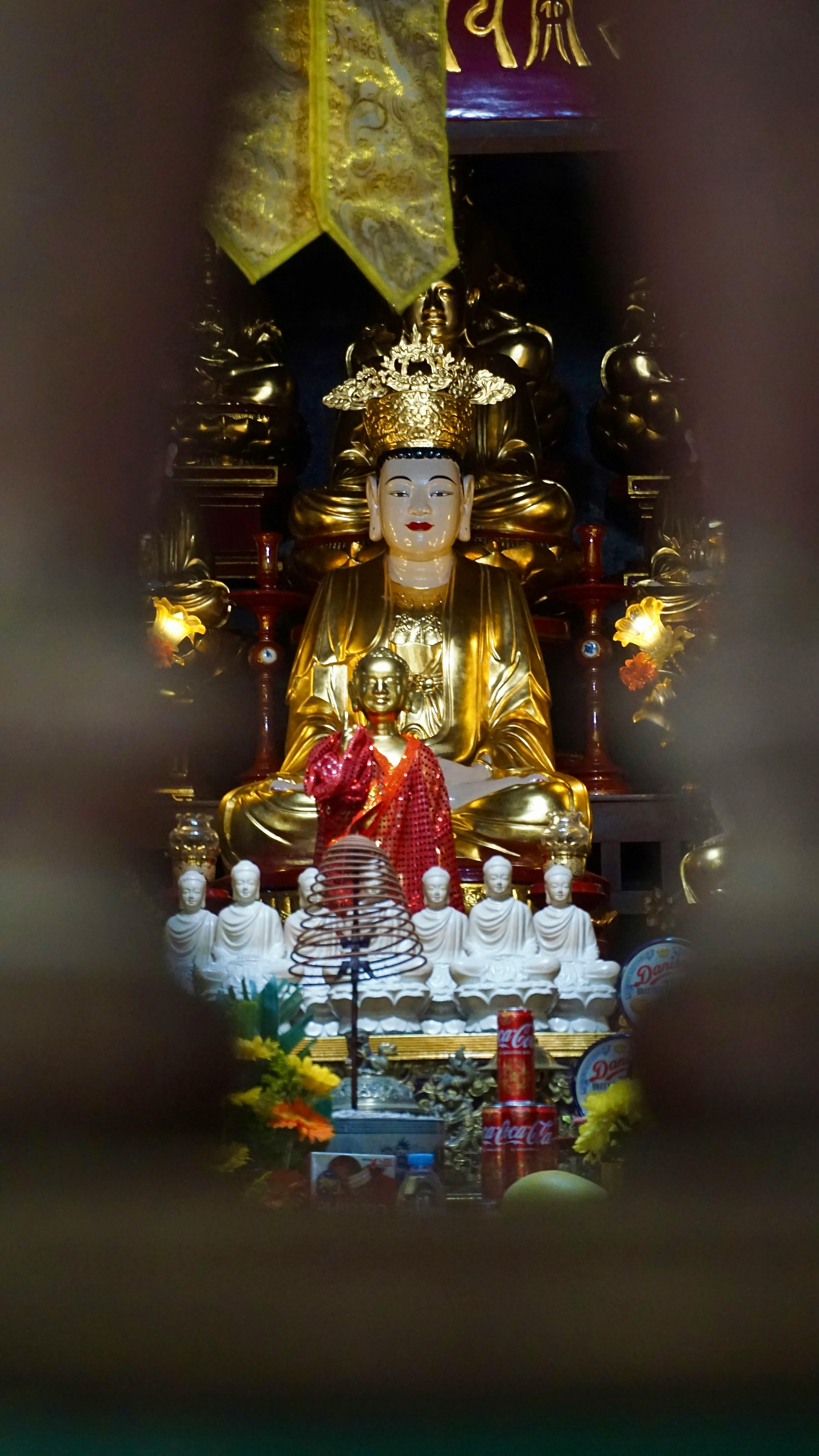 Peaceful Buddhist altar with statues and incense at Bich Dong Temple, Vietnam.