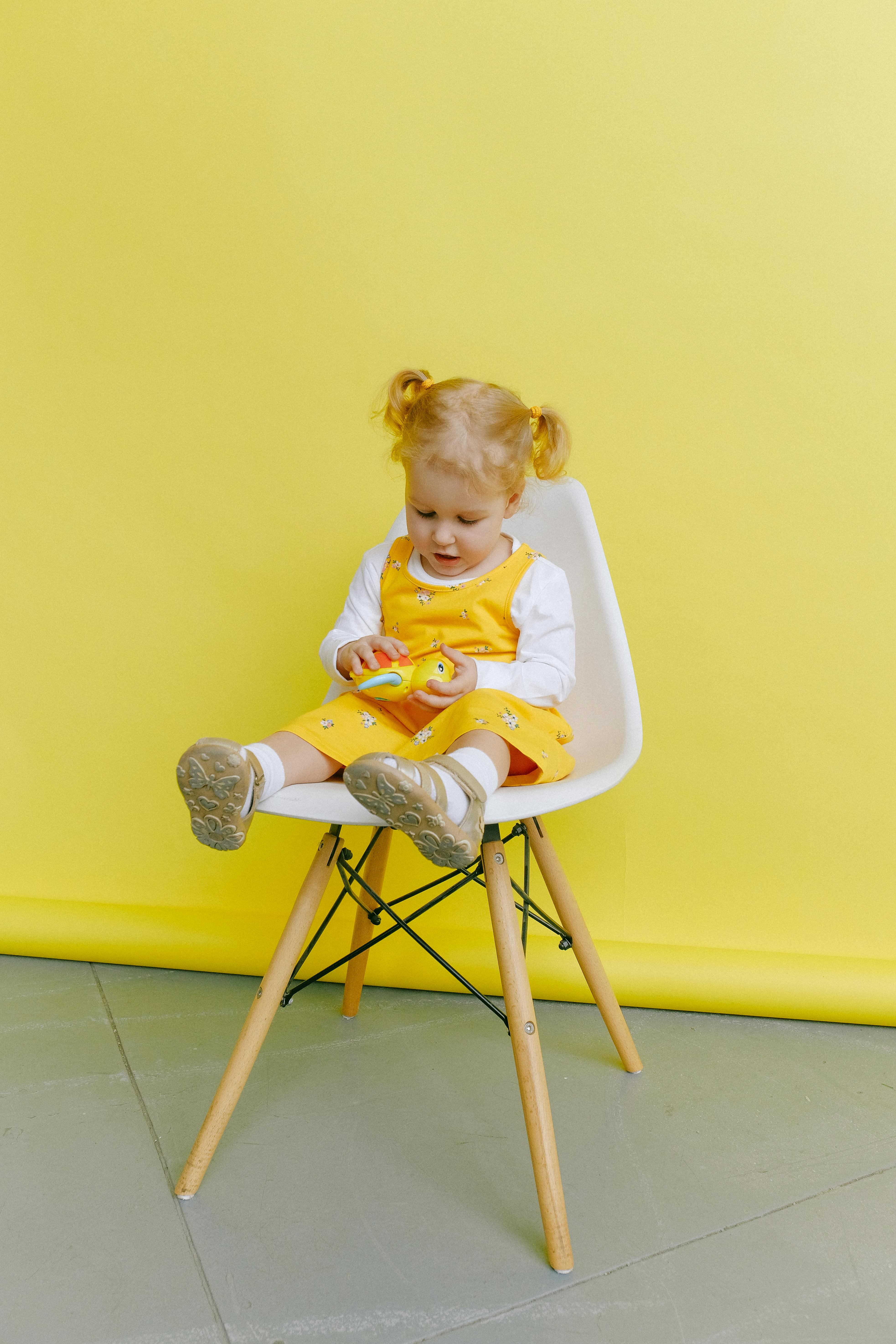Baby Girl Sitting On Chair Free Stock Photo